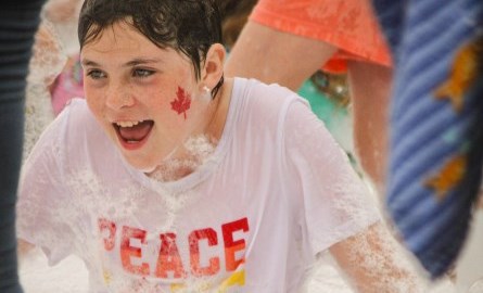 smiling boy covered in foam