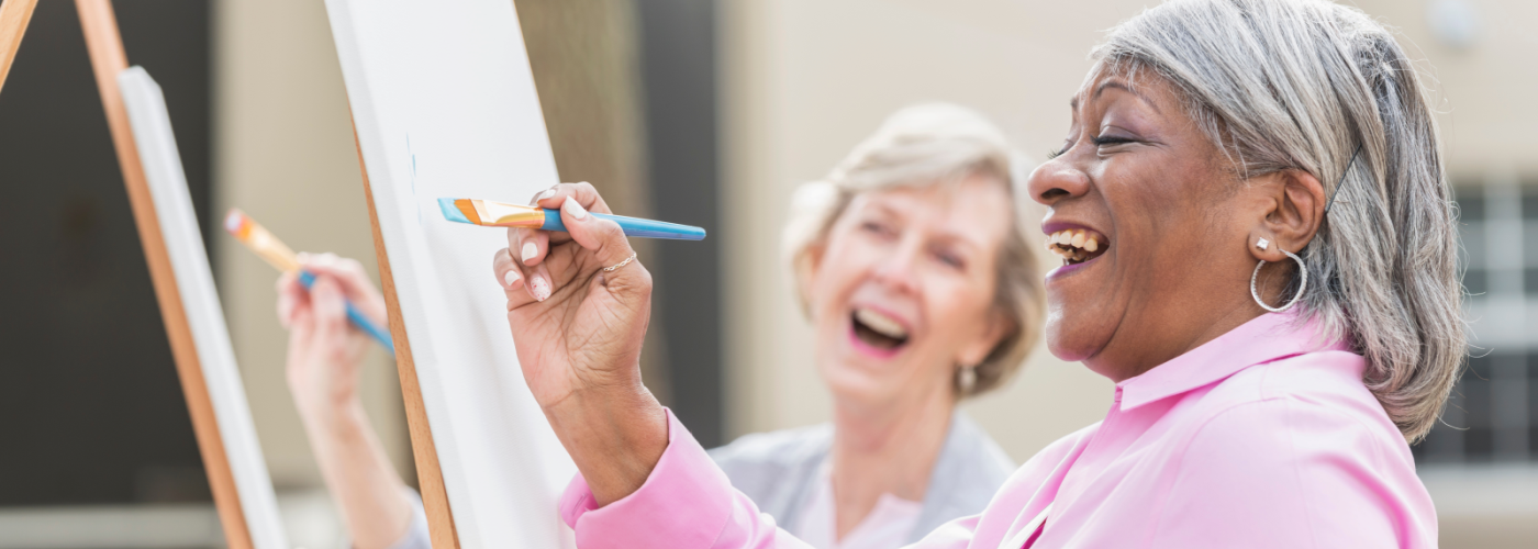 two women enjoying an art class