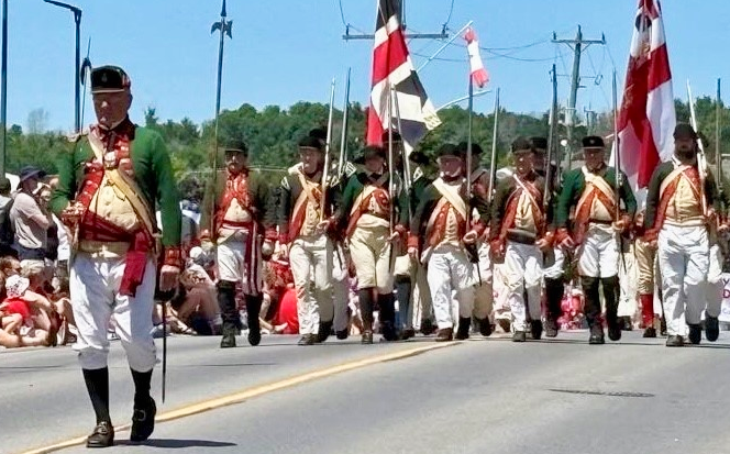 men marching in period uniform on Canada Day