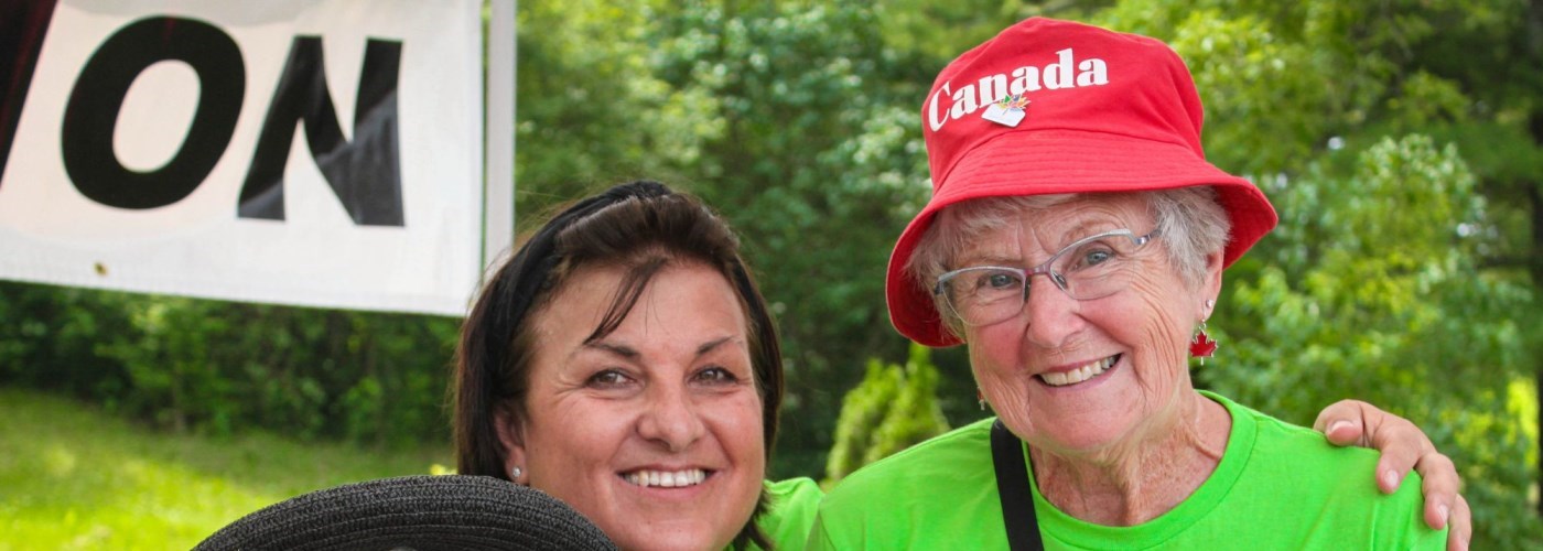 women smiling in green volunteer t-shirts