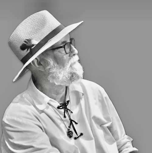 black and white image of mature bearded man in Panama hat