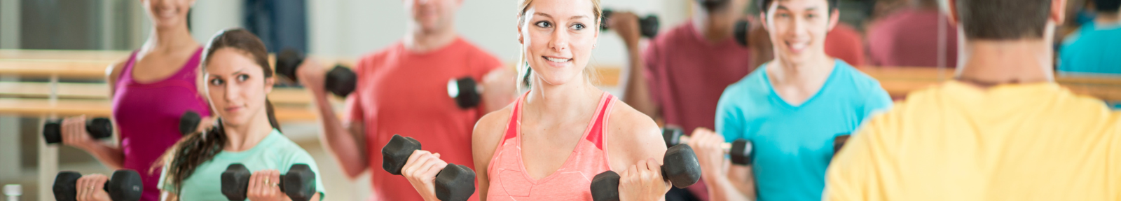 women in fitness class lifting hand weights