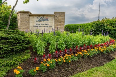 flower beds and stone sign for Island View Park