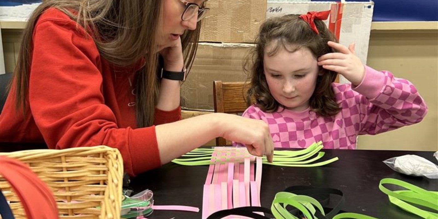 adult and child doing a papercraft