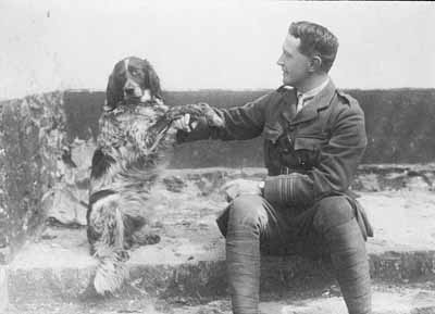 man in army uniform and his dog