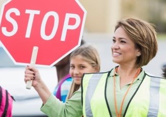 crossing guard holding stop sign