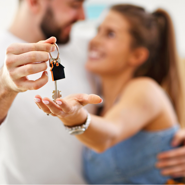 Couple holding keys to home