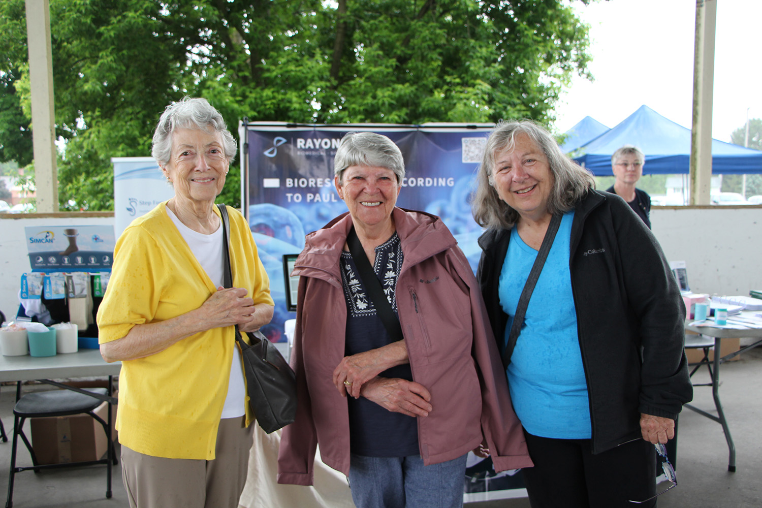 Three senior women smiling at event